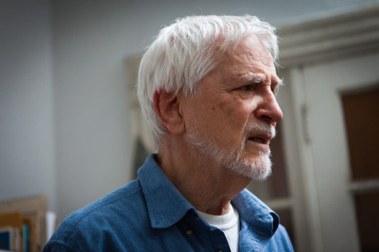 Lennart Anderson profile photo from the side, silver hair, clippered beard, looking concerned
