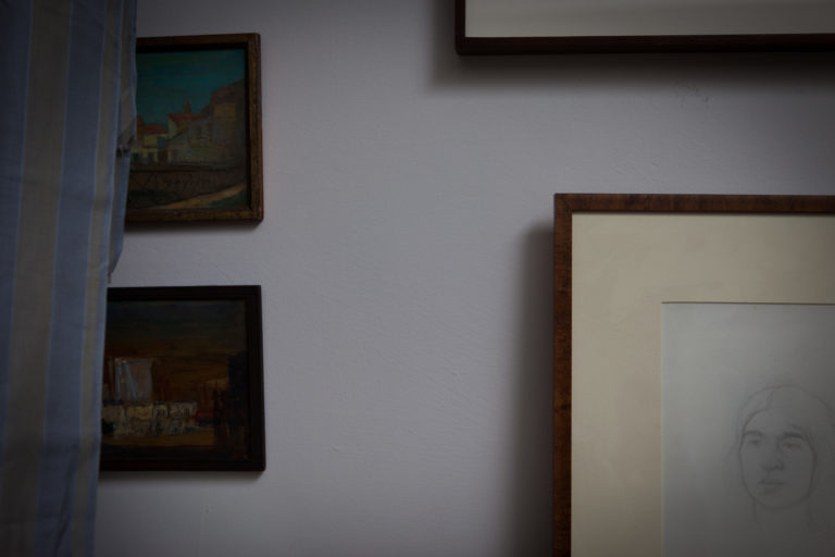 Studio interior of framed works of art on a wall