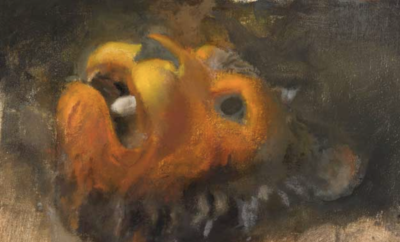 close up painting of orange lion's mask laying on its back